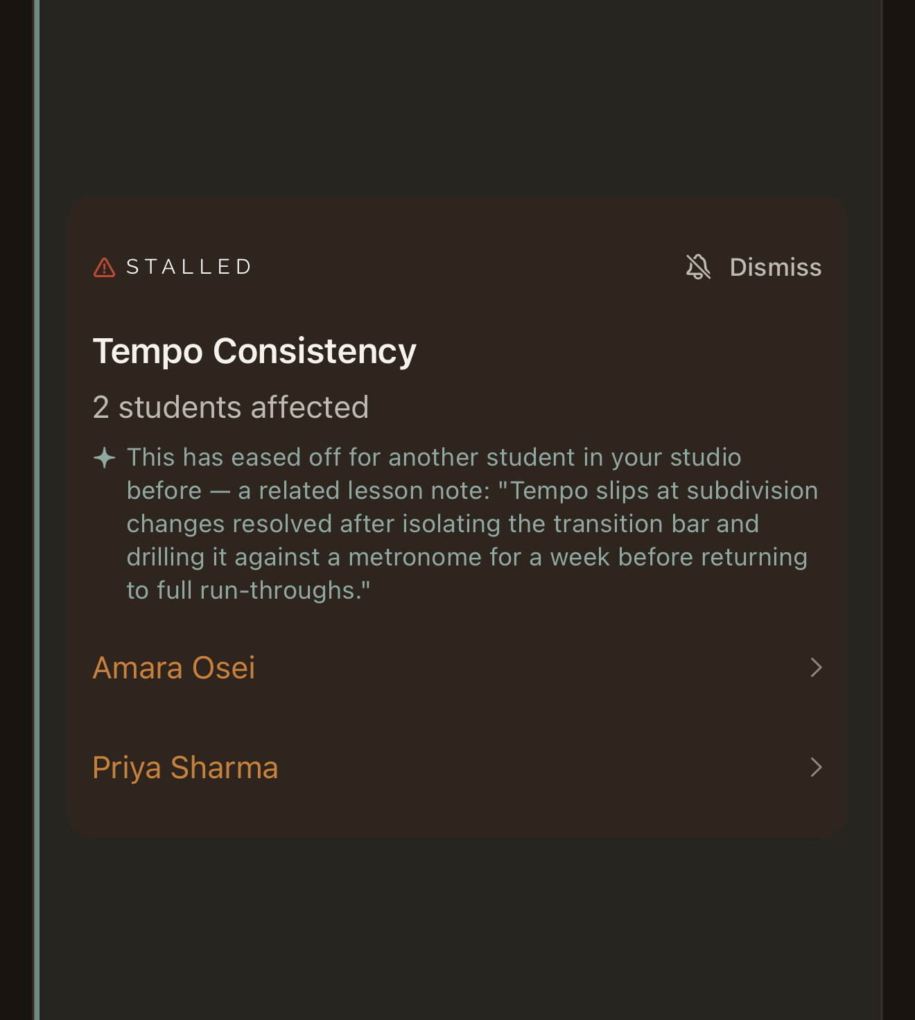 A Reflect flag in the app: Tempo Consistency has stalled, with 2 students affected, Amara Osei and Priya Sharma, and a note from another student in the studio on what helped before: isolating the transition bar and drilling it against a metronome