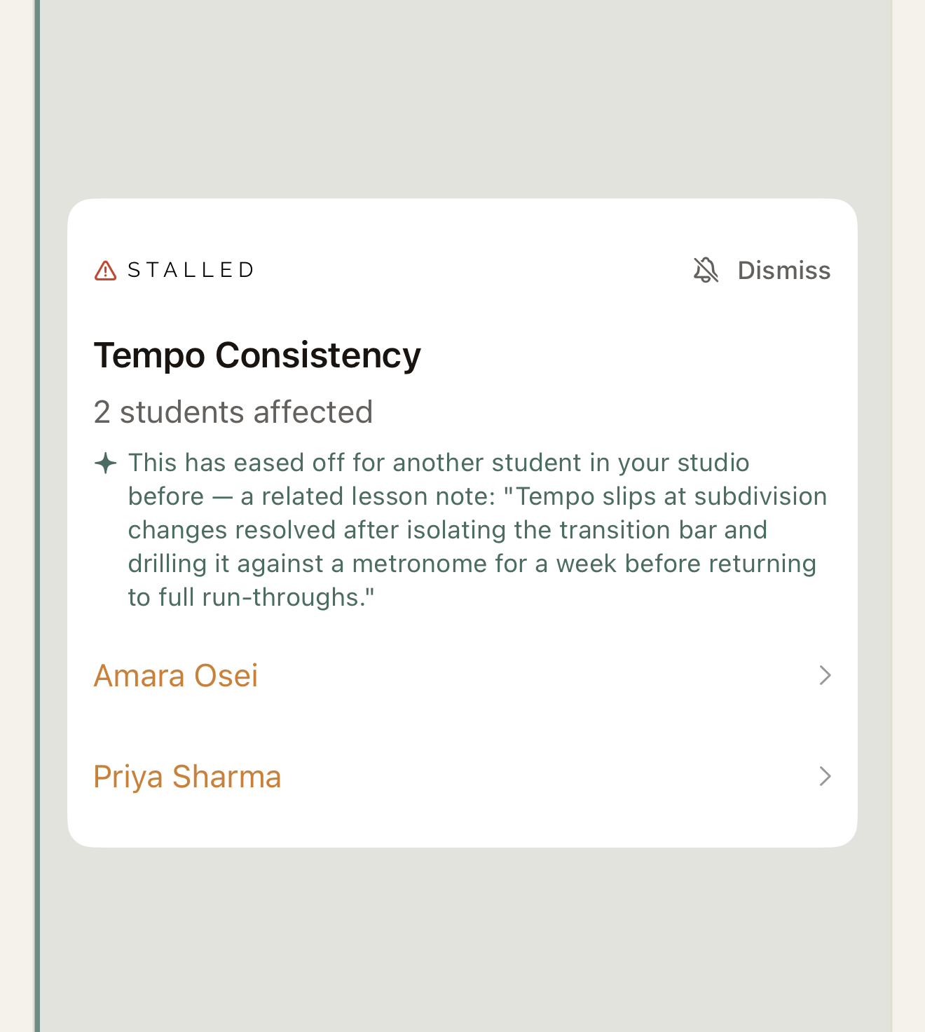 A Reflect flag in the app: Tempo Consistency has stalled, with 2 students affected, Amara Osei and Priya Sharma, and a note from another student in the studio on what helped before: isolating the transition bar and drilling it against a metronome